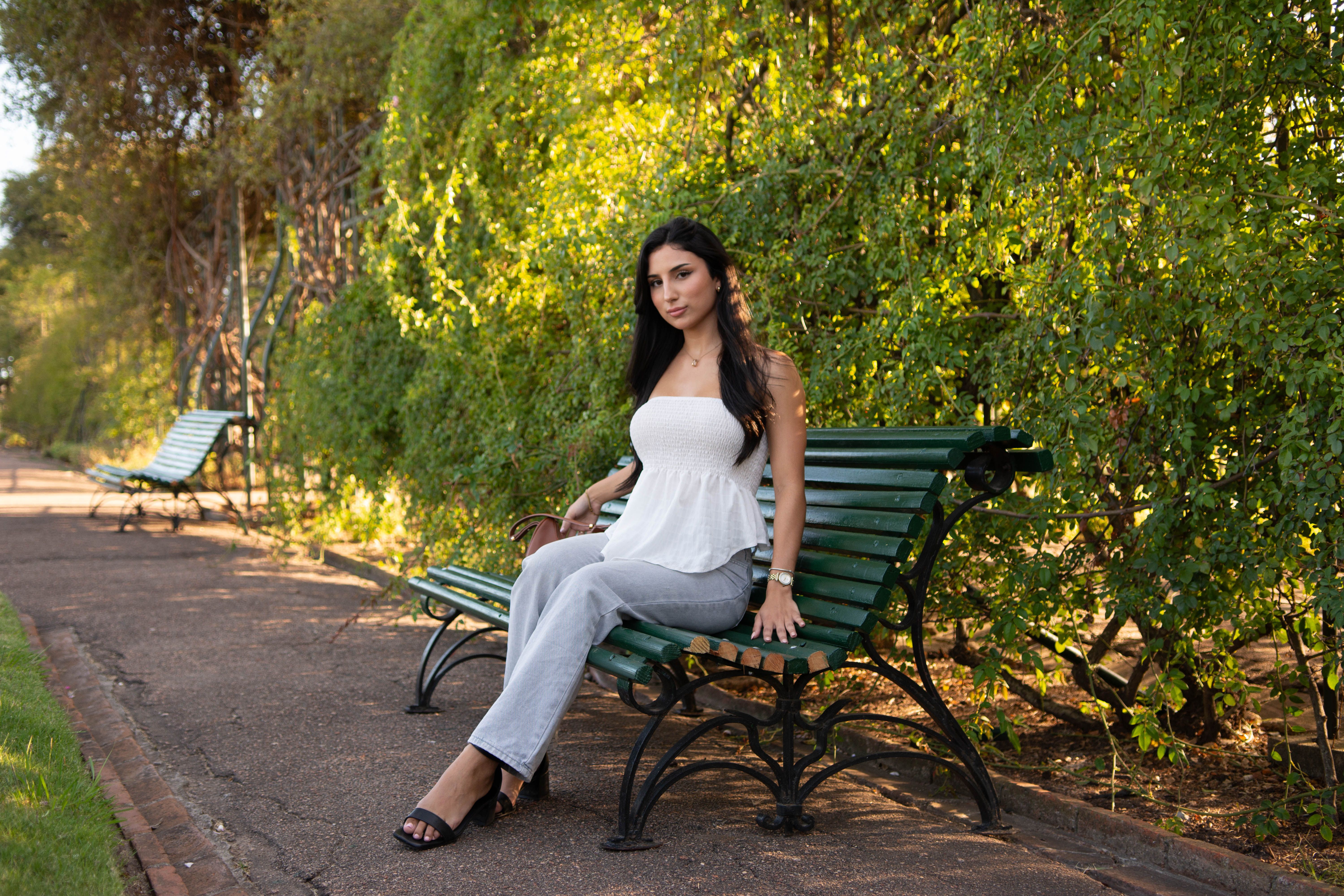 Woman Relaxing on Park Bench in Sunny Park · Free Stock Photo