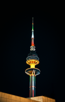 Stunning night view of Liberation Tower in Kuwait City, illuminated against the dark sky.