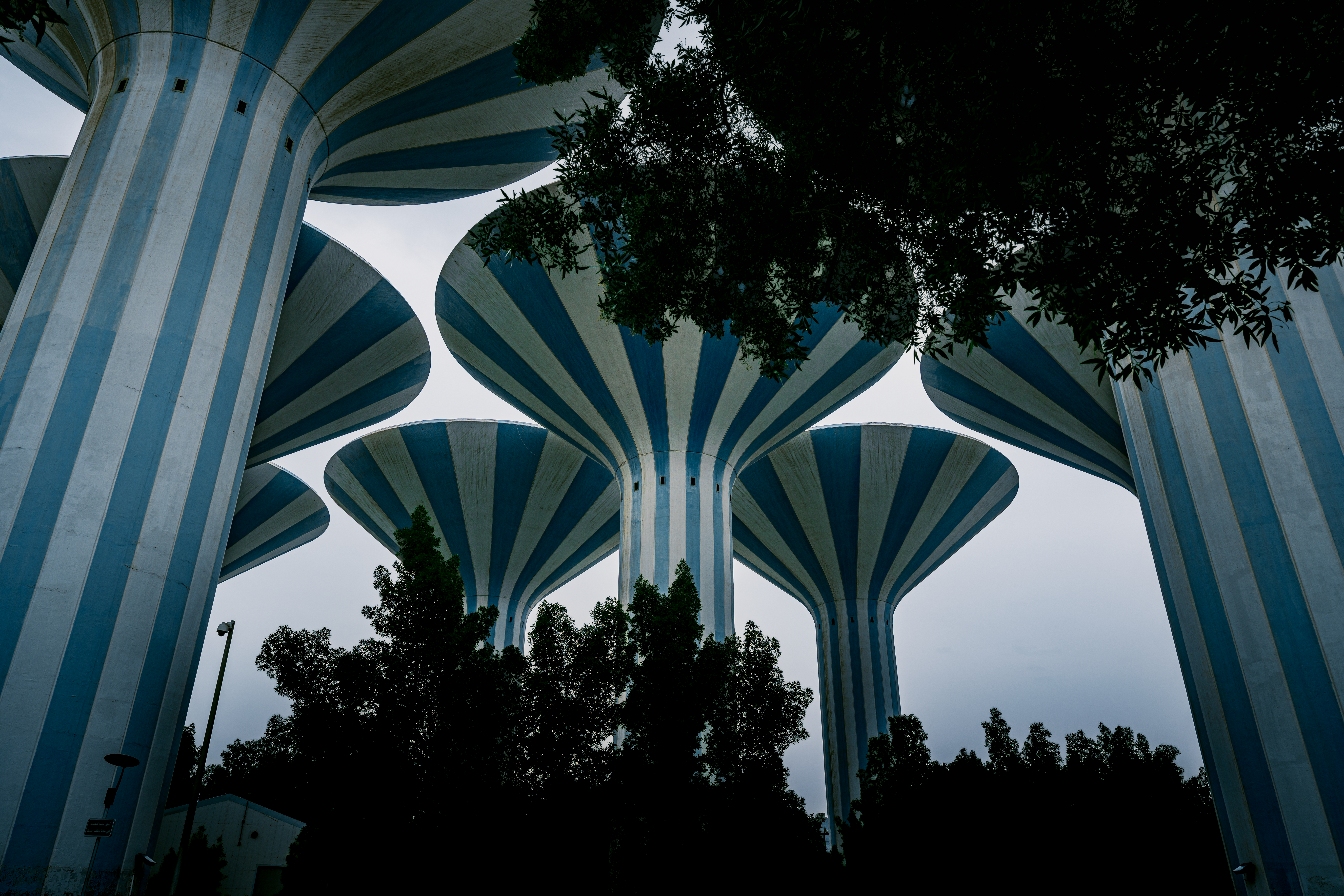 Stunning view of Kuwait water towers, showcasing distinctive architecture above the trees.