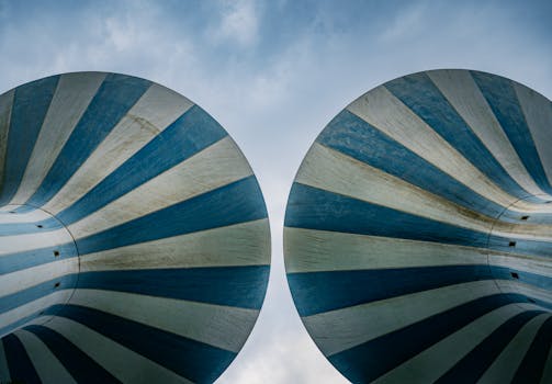 Striking view of Kuwait Towers with blue and white stripes under a clear sky.