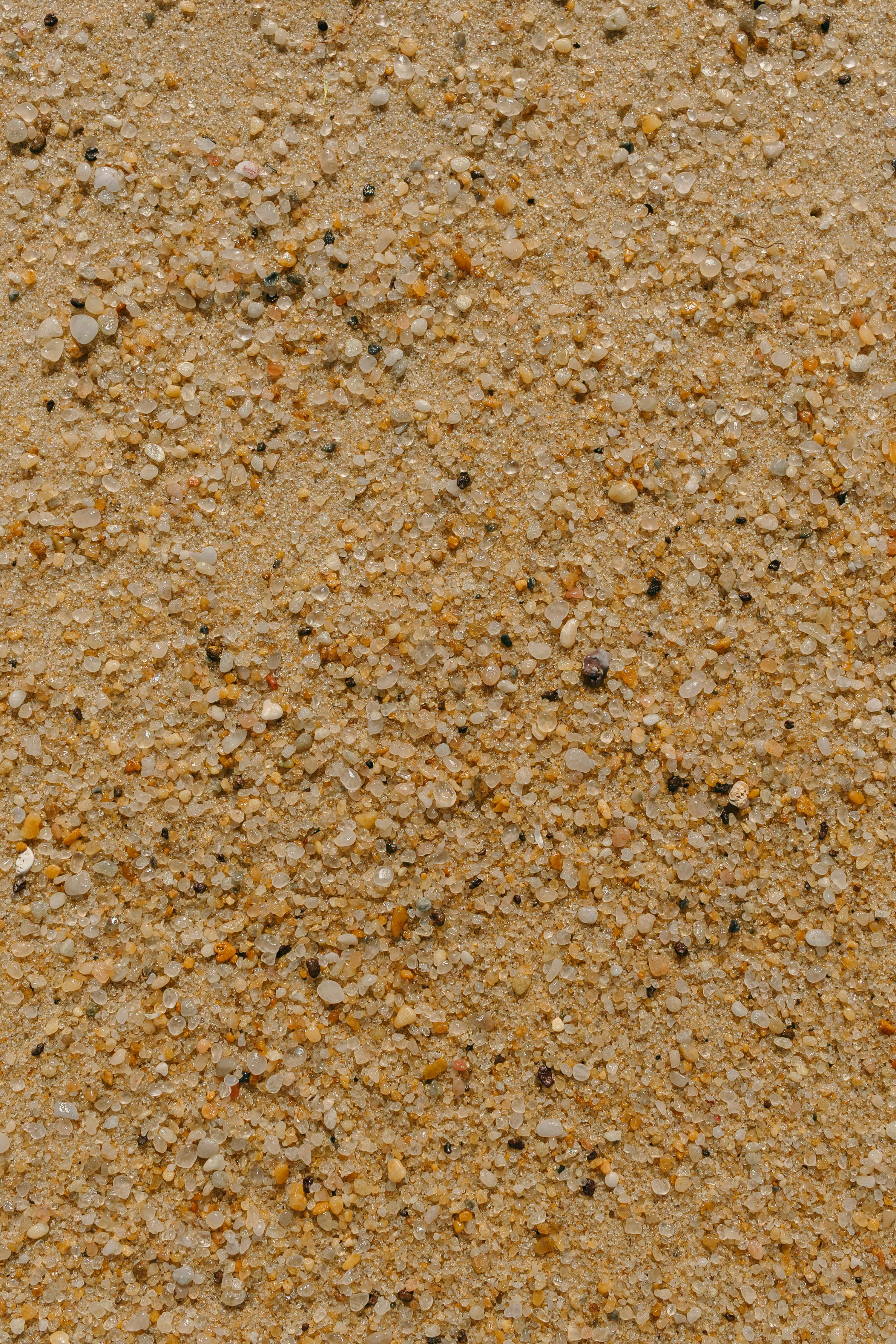 Kostnadsfria Högupplöst närbild av gyllene sandtextur, perfekt för bakgrunder och texturer. Stock foto