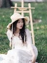 Young Woman in Straw Hat with Easel Outdoors