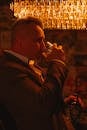 Charming Gentleman Enjoying Whiskey Under Warm Lighting