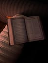 Open Quran Placed on Sofa Illuminated by Warm Light