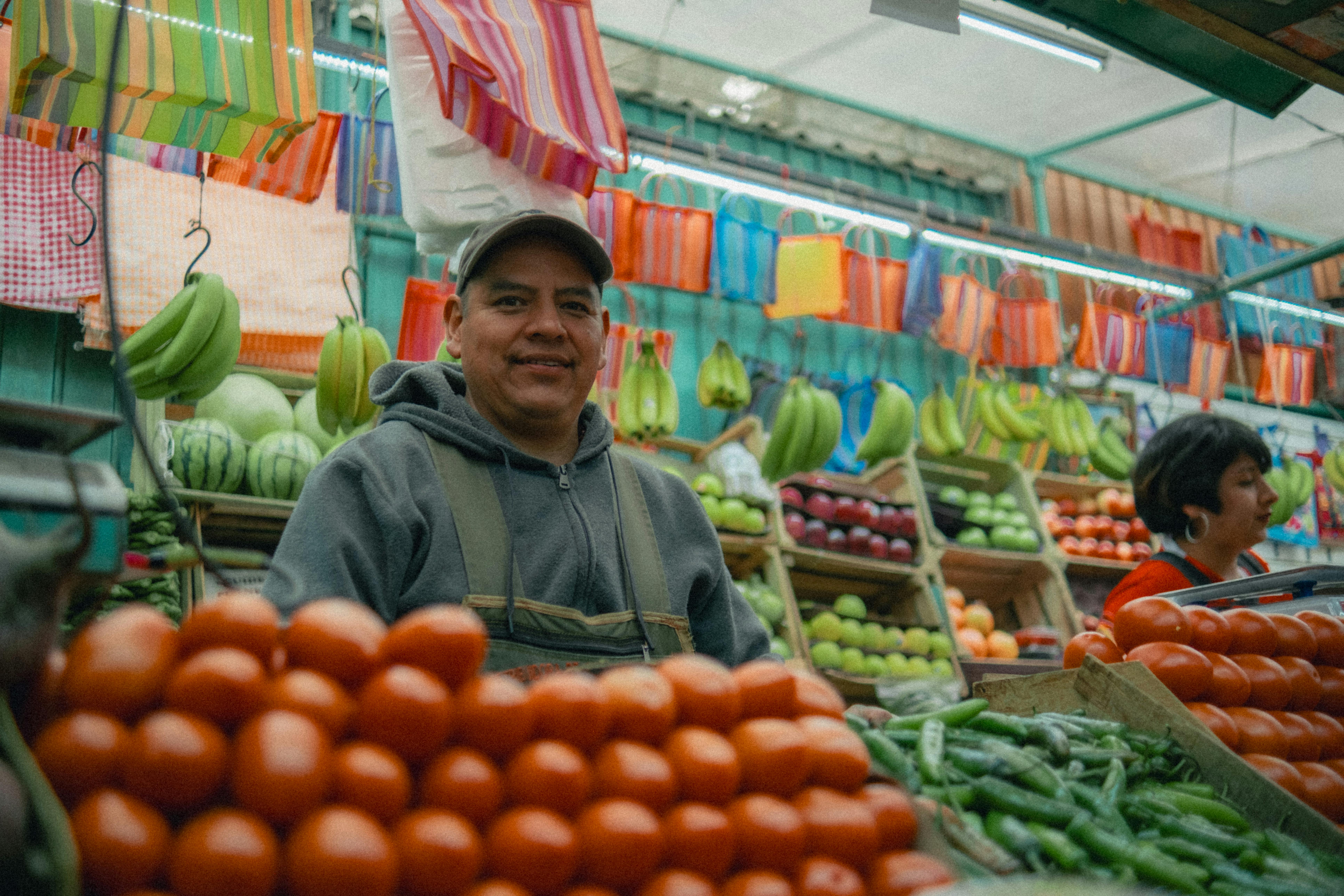 Colorful Mexican market with fresh fruits and vegetables and local vendors.