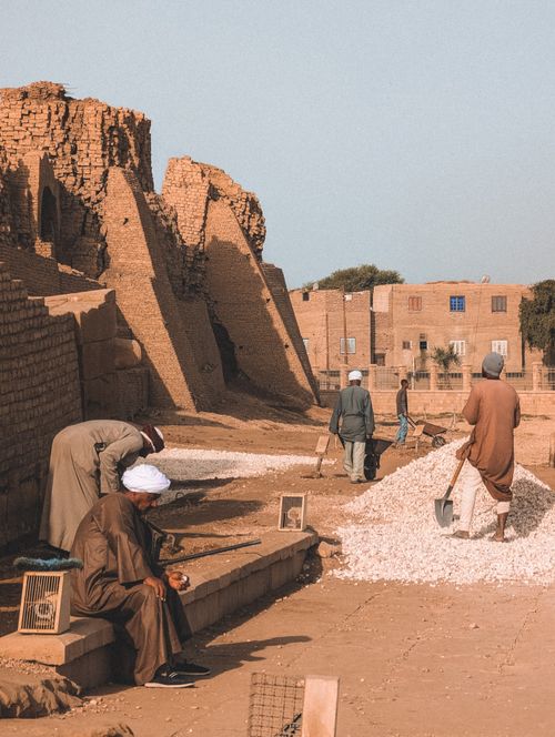 Free Exploring daily life and architecture in Qena Governorate, Egypt, with locals engaged in community activities. Stock Photo