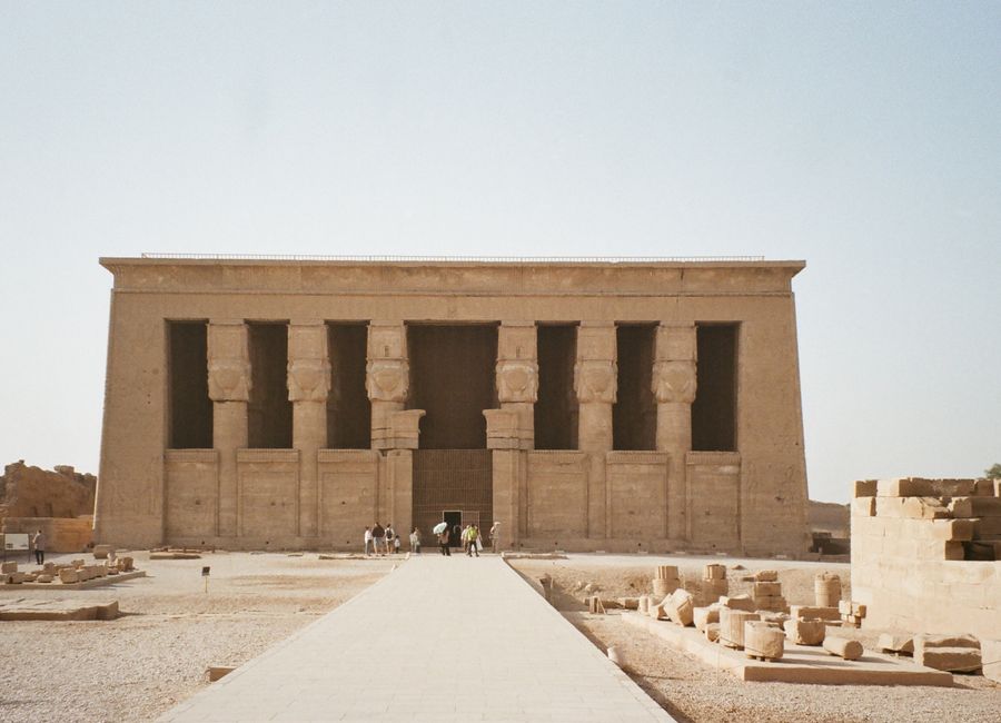 Front view of the Temple of Hathor in Dendera, Qena, Egypt with clear blue sky.
