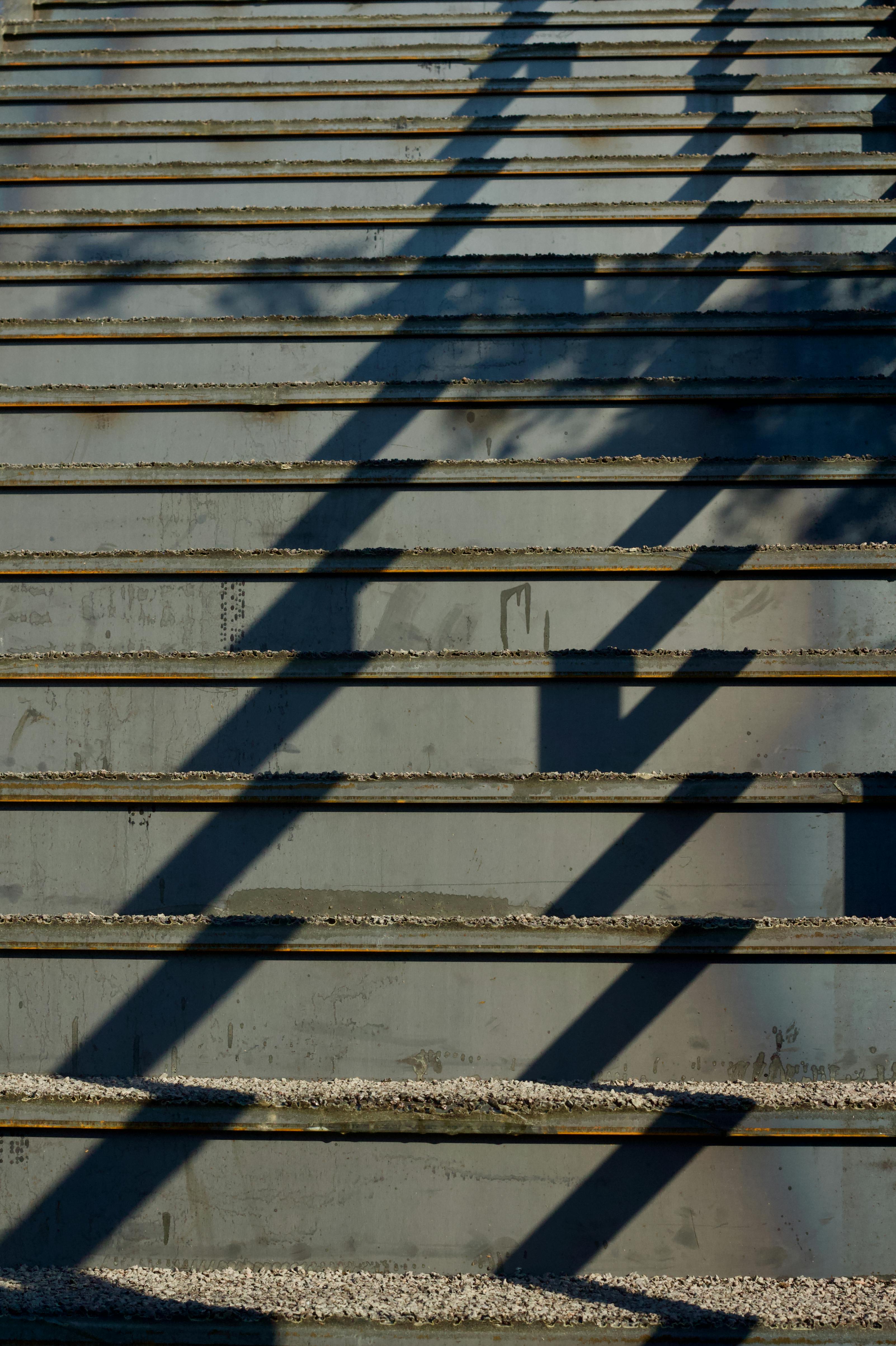 Free Steps with dramatic diagonal shadows under daylight creating an abstract pattern. Stock Photo