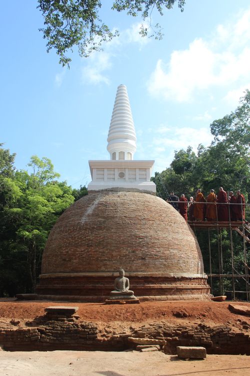 Free A serene white stupa surrounded by lush greenery in Sri Lanka, showcasing Buddhist architecture. Stock Photo