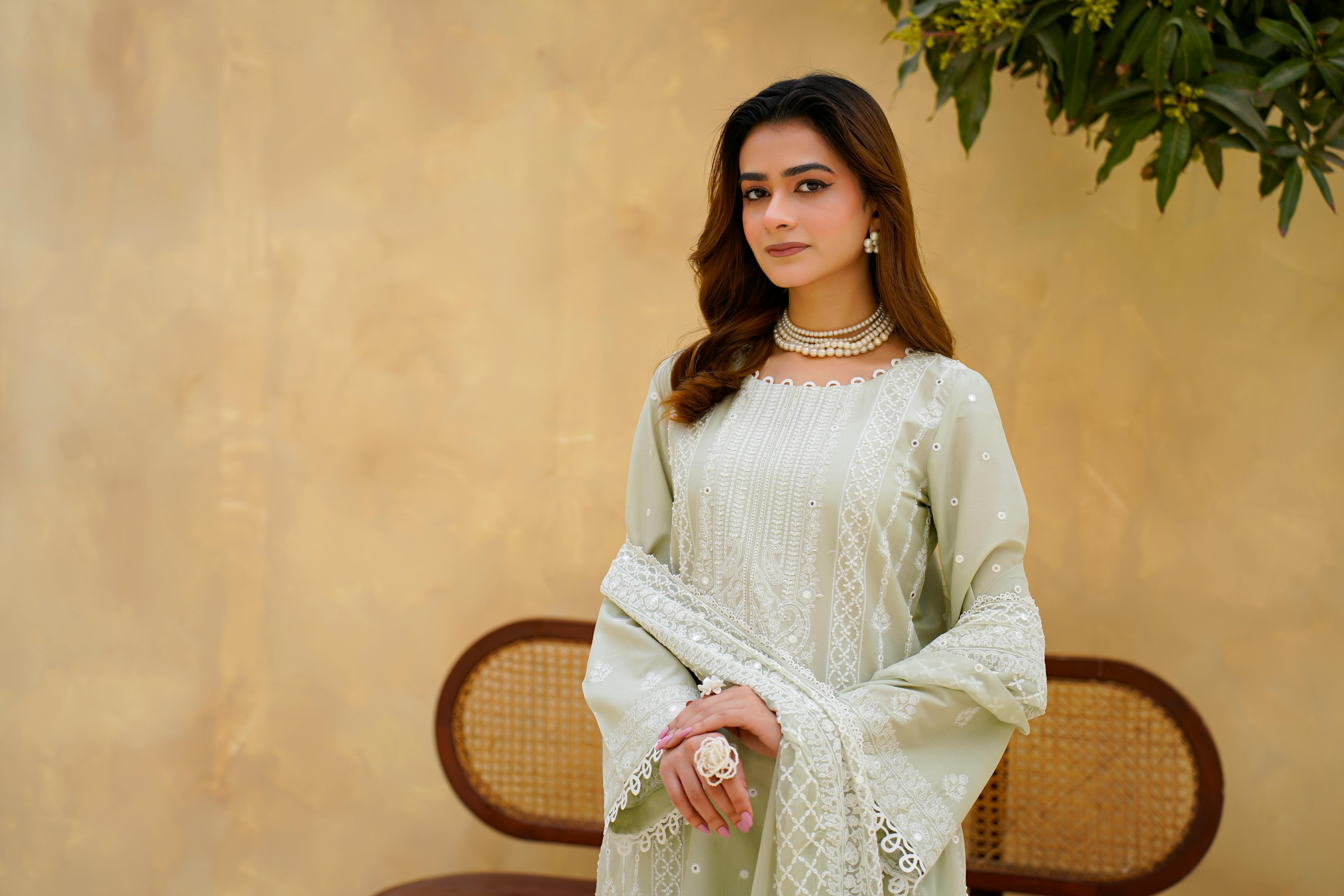 Elegant portrait of a woman in traditional Eastern dress with intricate embroidery, photographed outdoors in Lahore.
