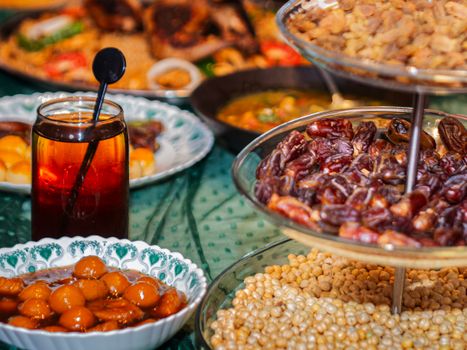 A vibrant table spread with dates, sweets, and juices, commonly enjoyed during Iftar.