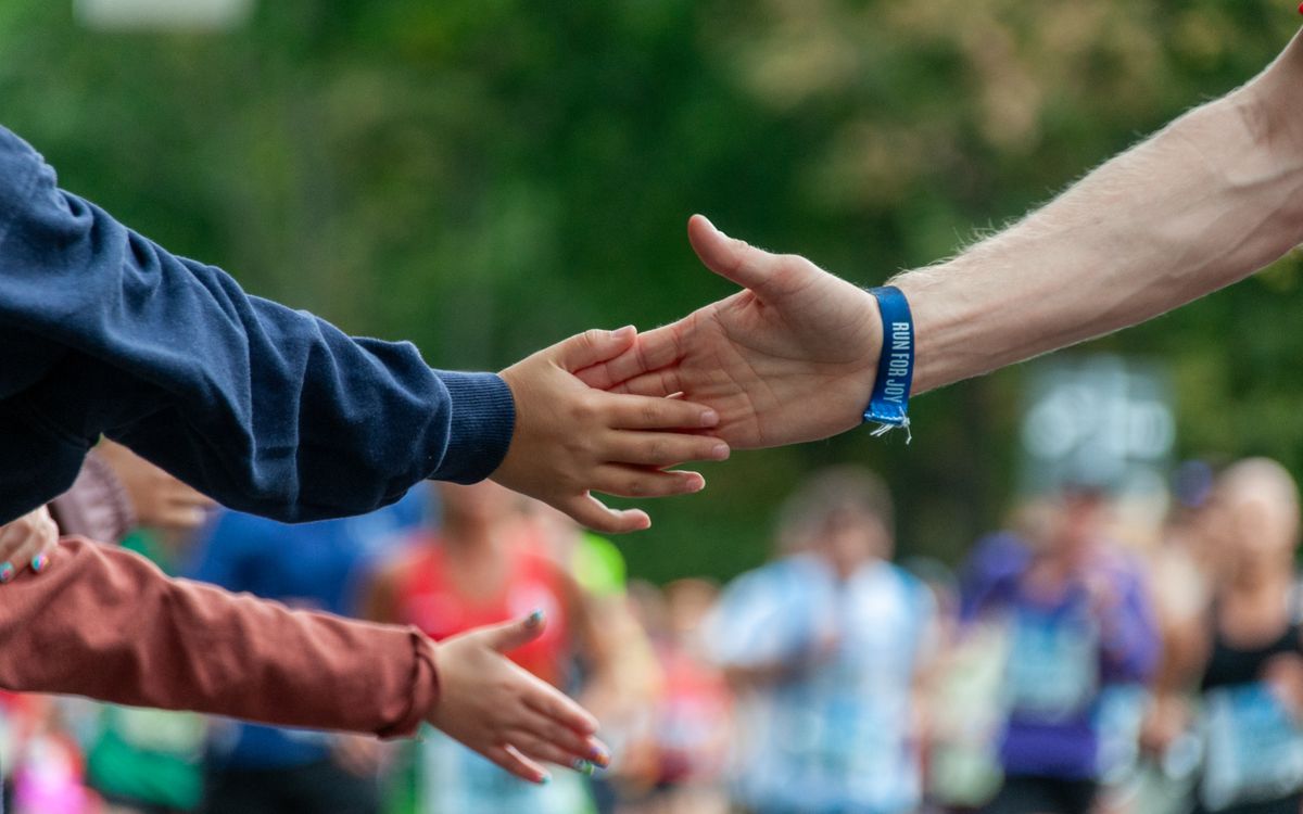 A spectator high-fiving a runner