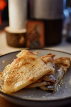 Mouth-watering homemade crepes served on a plate, perfect breakfast treat.