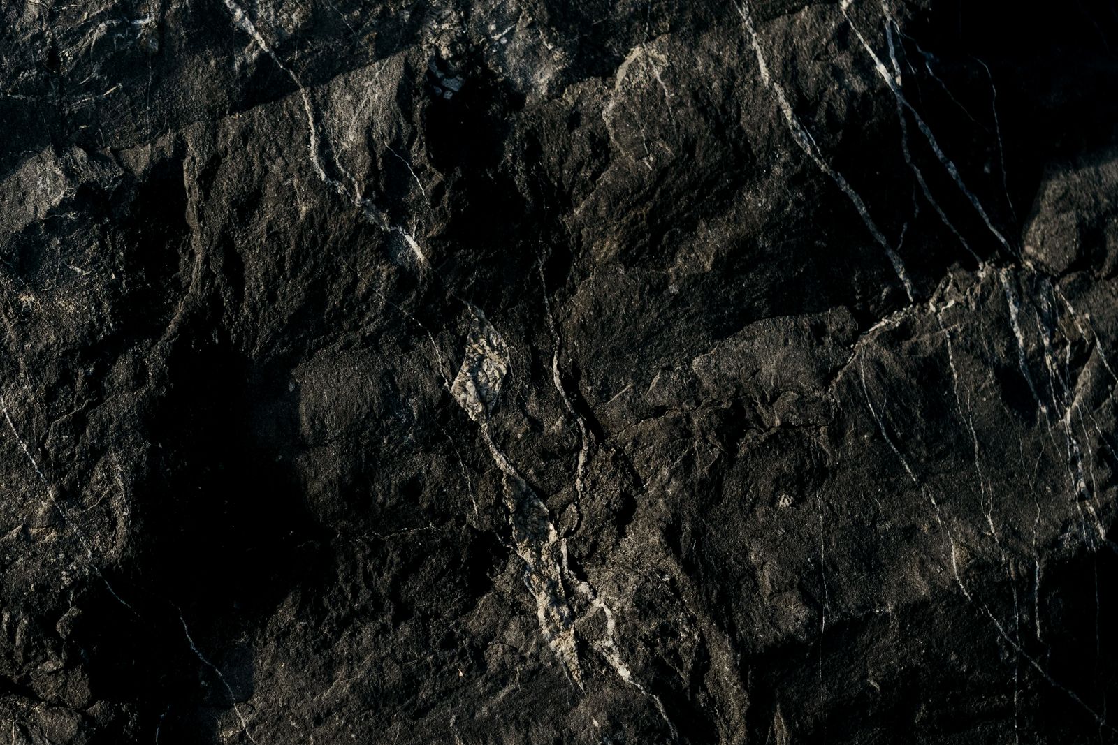 Dark veined stone surface — photo by Andrea Prochilo on Pexels