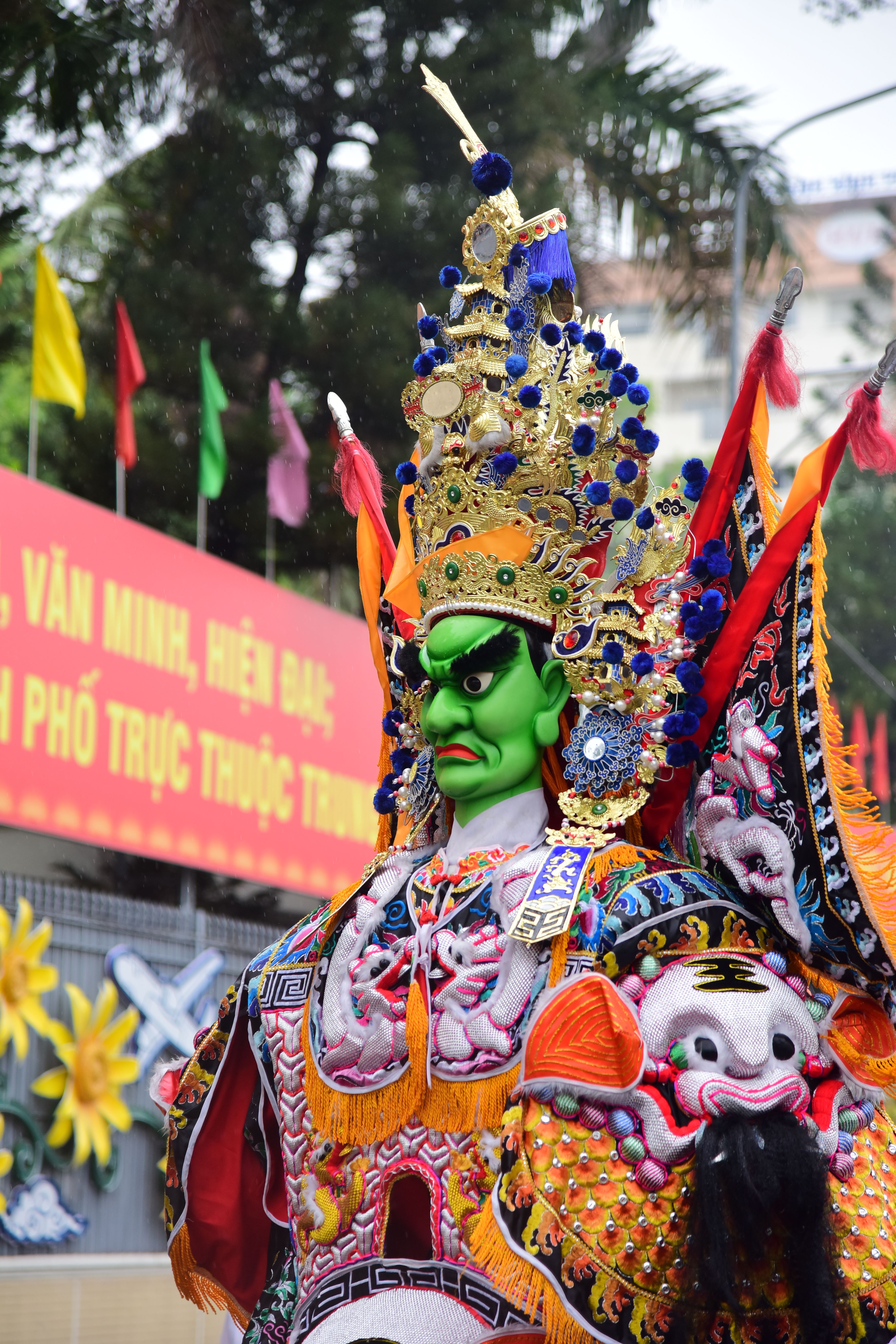 Vibrant Chinese opera costume in street parade with bright decorations and cultural significance.