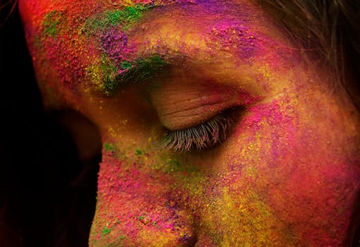 Close-up of a face covered in vibrant Holi colors during the festival in Janakpur, Nepal.
