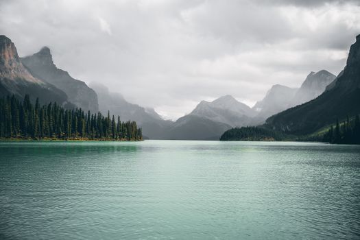 Breathtaking view of picturesque turquoise lake surrounded by mountains. Perfect for nature lovers.