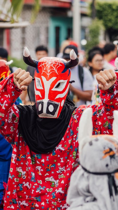 Free Vibrant festival participant in traditional costume with an ornate mask in Yurimaguas, Peru. Stock Photo