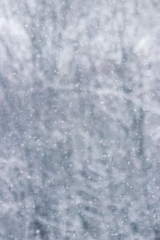 Abstract background of a winter snowfall, creating a serene and cool atmosphere.