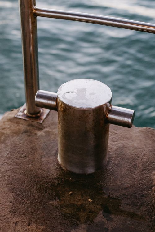 Free A close-up of a metal bollard on a pier by the sea in Bahia, Brazil. Stock Photo