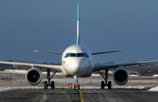 A commercial airplane stands on the runway at Sylt airport, Germany in winter.