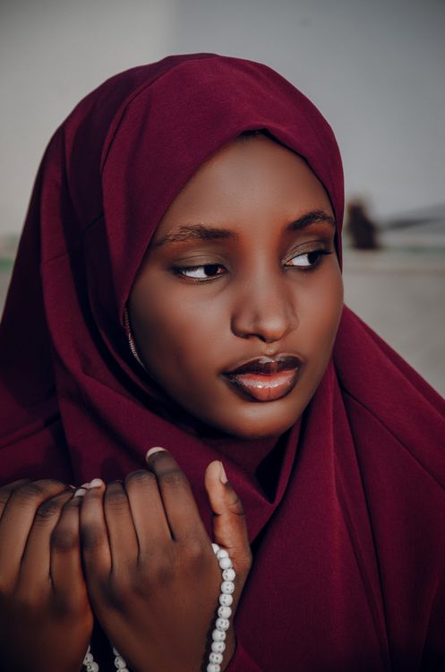 Portrait of a Woman in Maroon Hijab Holding Prayer Beads · Free Stock Photo