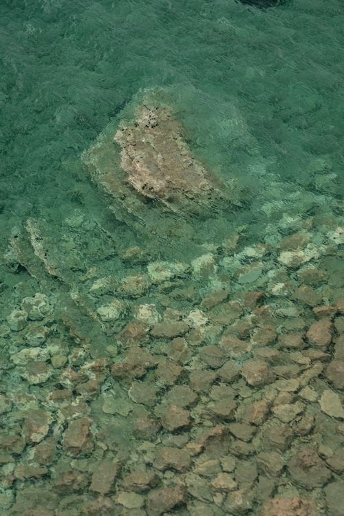 Free A top view of rocky sea floor under crystal clear aqua waters in Budva, Montenegro. Stock Photo