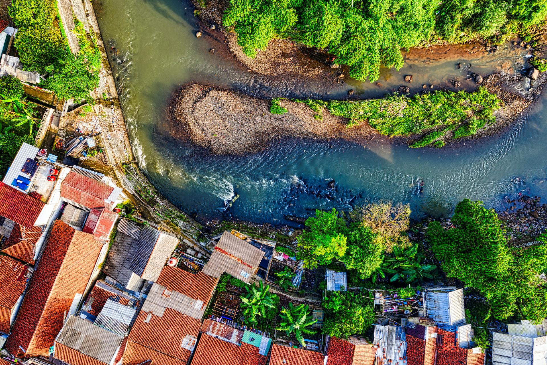 Aerial Footage of Creek Near Houses