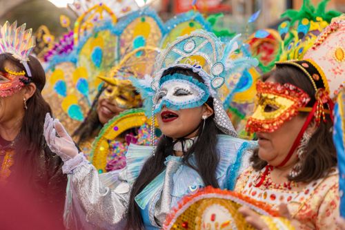 Free Vibrant carnival dancers in colorful masks and costumes celebrate in Tarma, Peru. Stock Photo