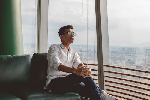 Man Sitting On Sofa