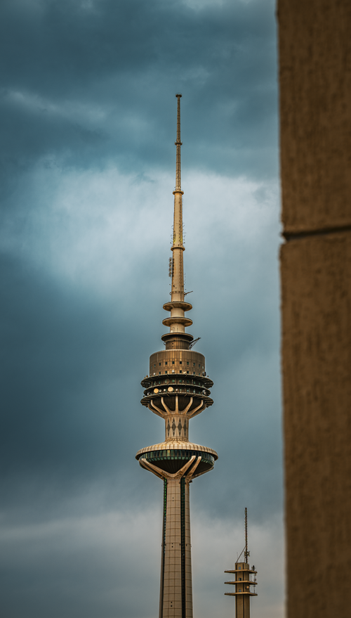 Free A striking view of the Kuwait Liberation Tower with a dramatic cloudy sky background. Stock Photo