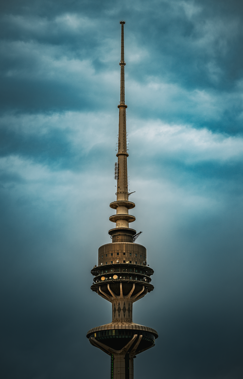 Free The iconic Liberation Tower in Kuwait City stands tall against a dramatic cloudy sky, showcasing modern architecture. Stock Photo