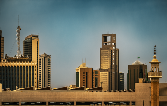 Skyline view of Kuwait City showcasing modern skyscrapers and traditional architecture.