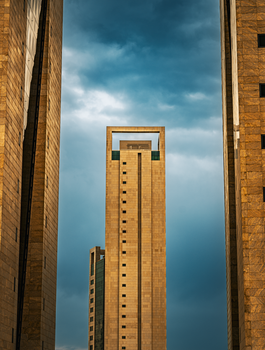 Striking view of modern towers in Kuwait City against a dramatic sky.