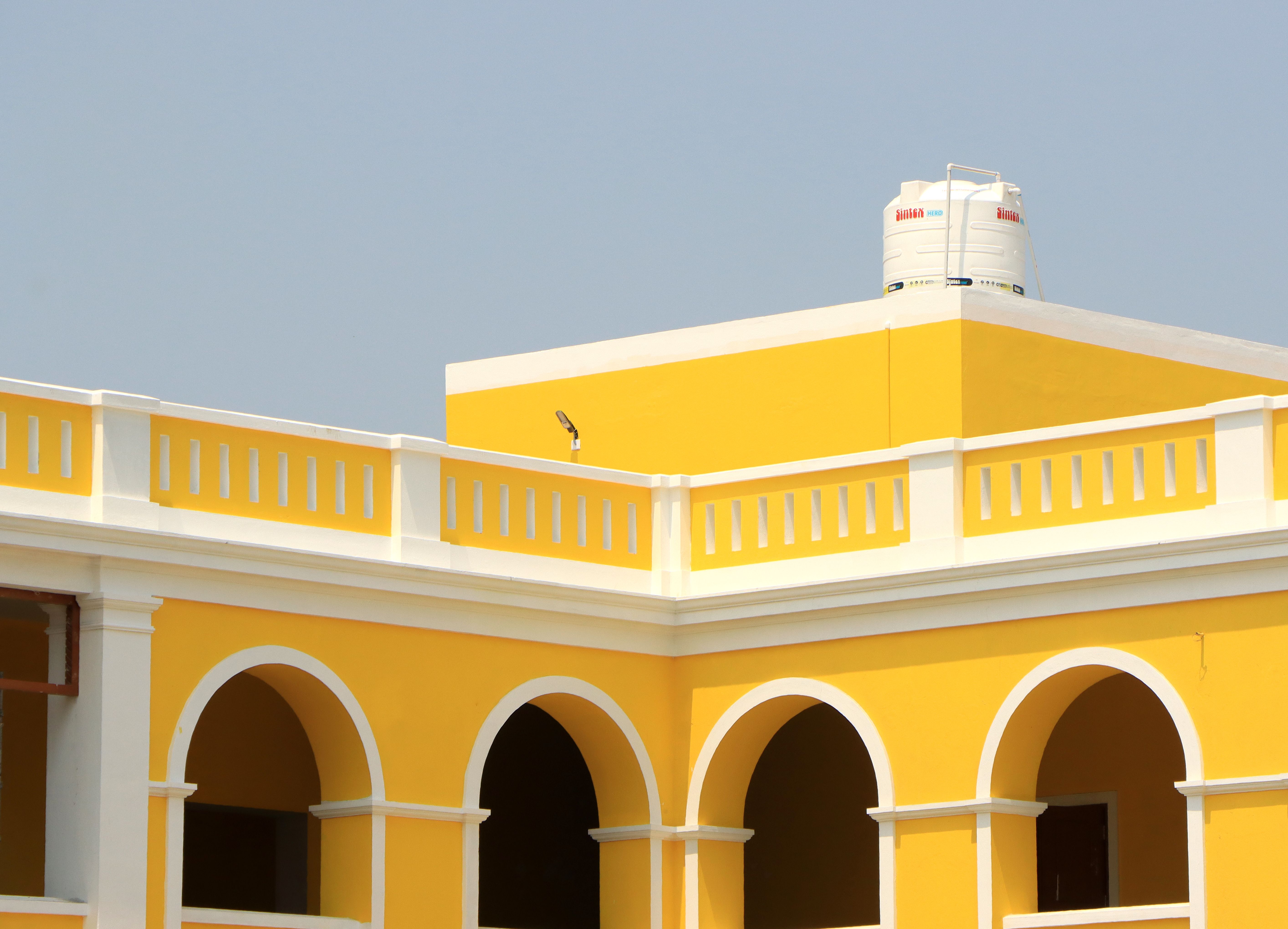 Bright Yellow Architectural Building with Arches · Free Stock Photo