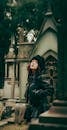 Stylish Woman in Gothic Cemetery Setting