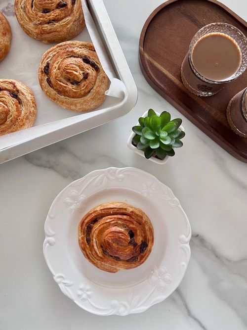 Free Top view of Danish pastries, succulent plant, and coffee on a marble table. Stock Photo