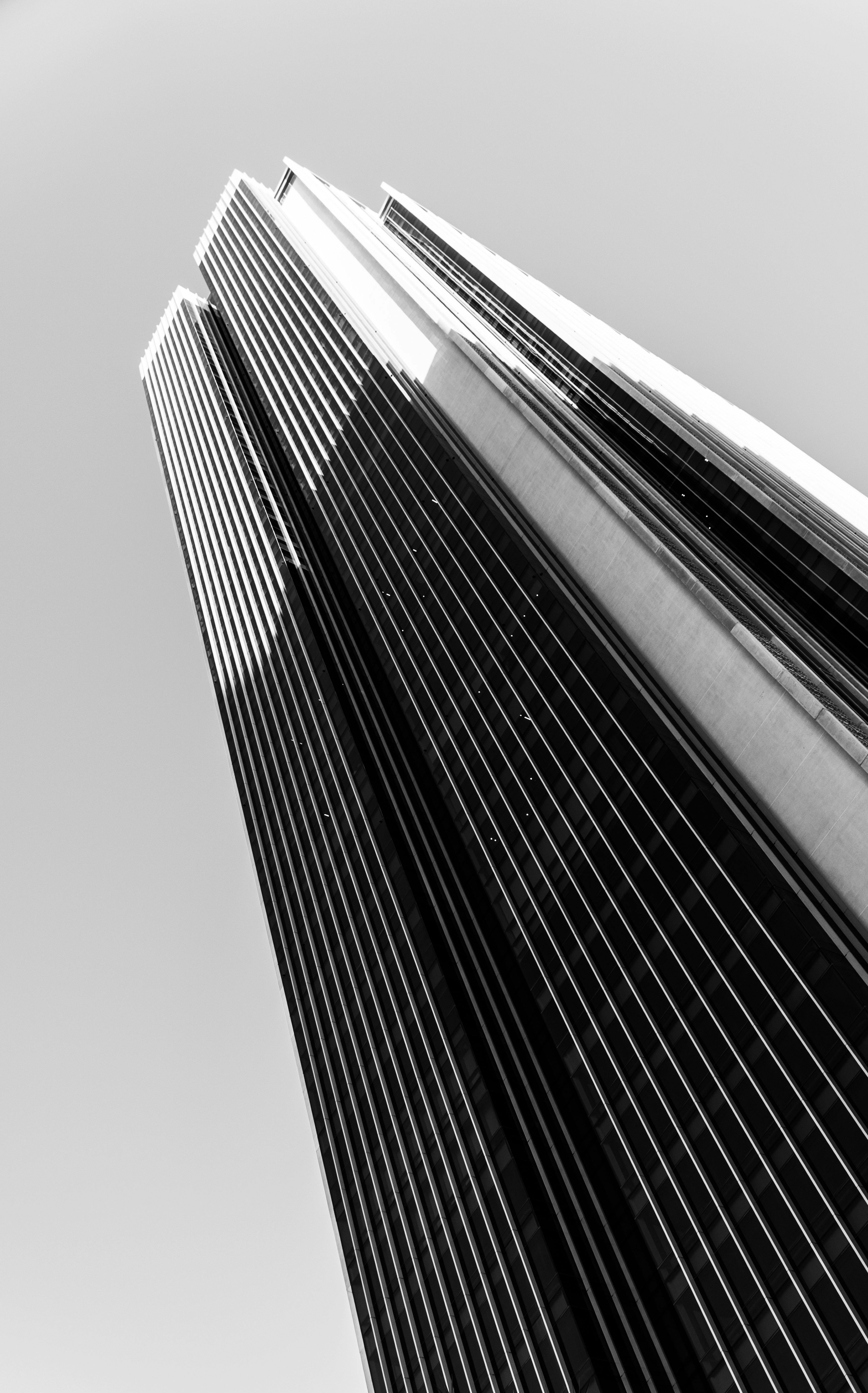 Gratuit Superbe photographie en noir et blanc d'un gratte-ciel moderne vu d'en bas. Photos