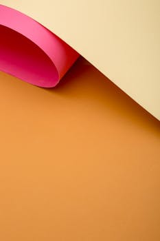 A vibrant abstract background featuring overlapping colored paper with a minimalist design.