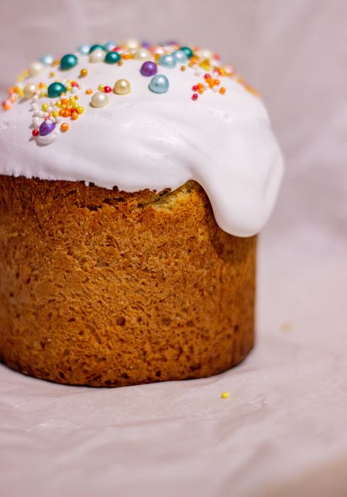 Free Close-up of a traditional Easter bread topped with white icing and colorful sprinkles. Stock Photo