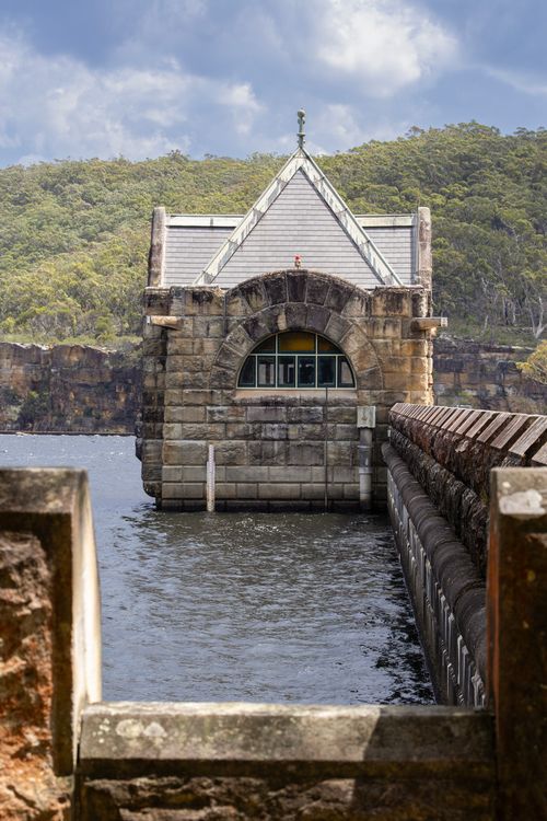 Free A scenic view of the stone structure at Cataract Dam, surrounded by lush greenery in Appin, NSW. Stock Photo