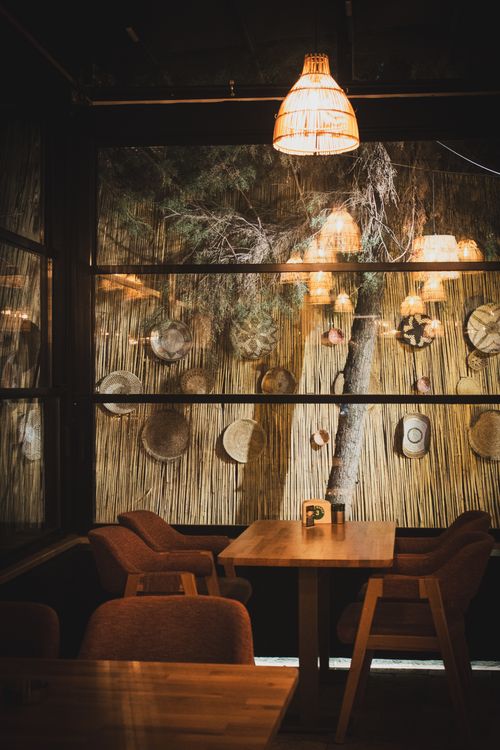 Free Warm, intimate café interior with rustic decor and dim lighting. Stock Photo