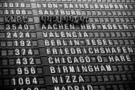 Black and white image of a vintage airport departure board displaying various international destinations.