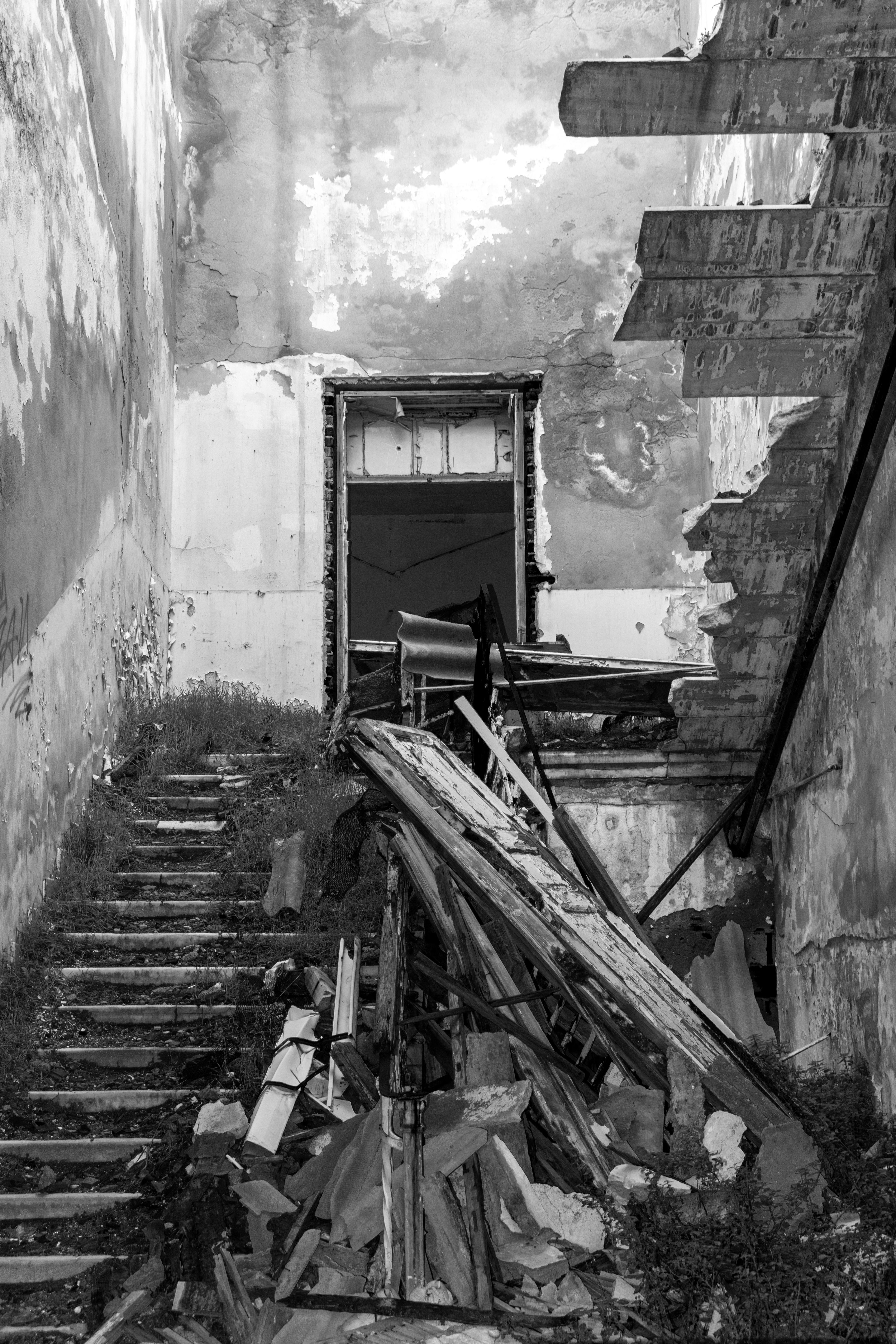 Free Black and white photo of a decaying staircase in a neglected, dilapidated building. Stock Photo