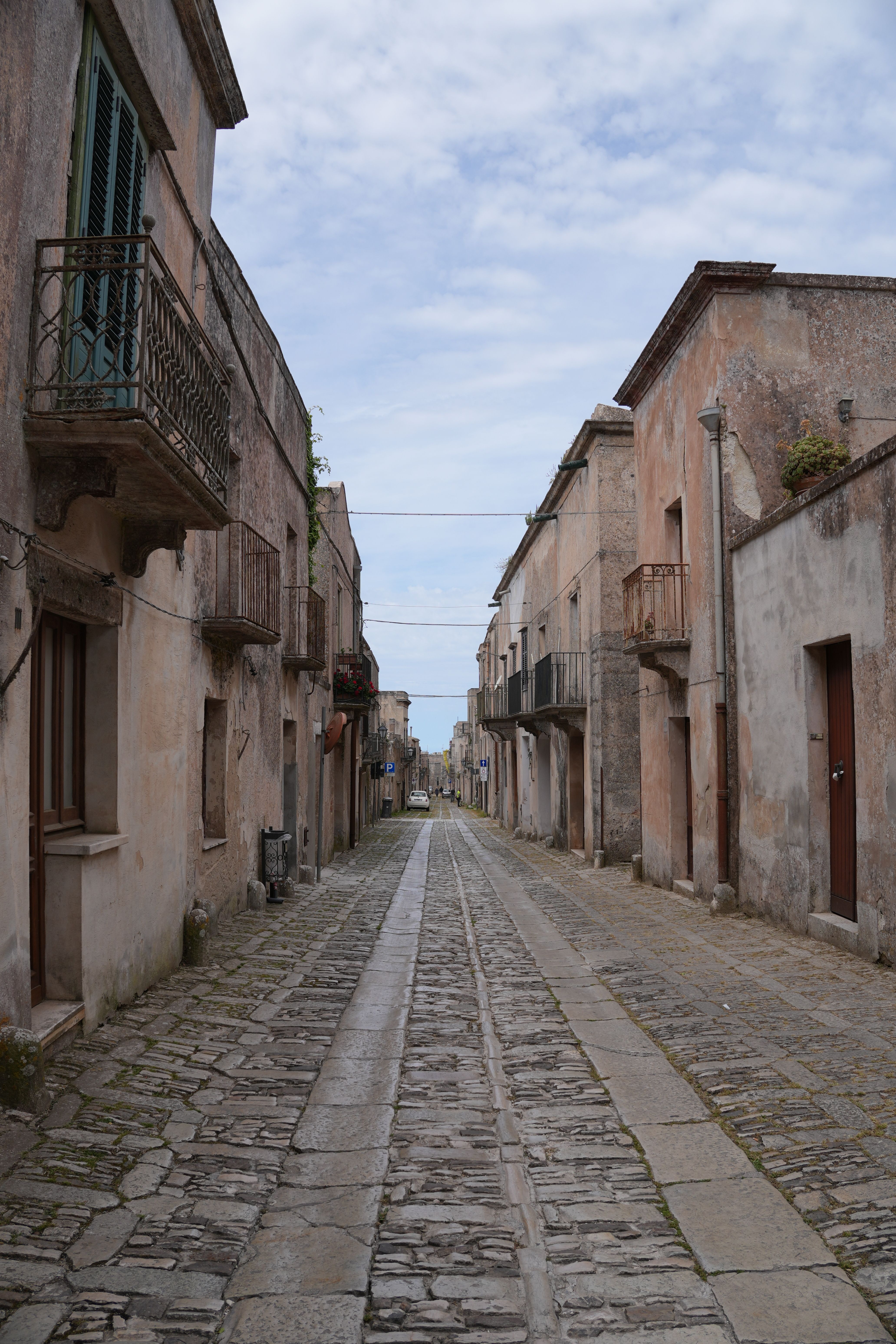 Explore the serene cobblestone streets of Erice, Sicily, lined with historic buildings.
