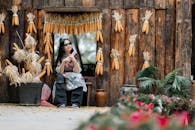Woman Relaxing by Rustic Corn Decorated Wall