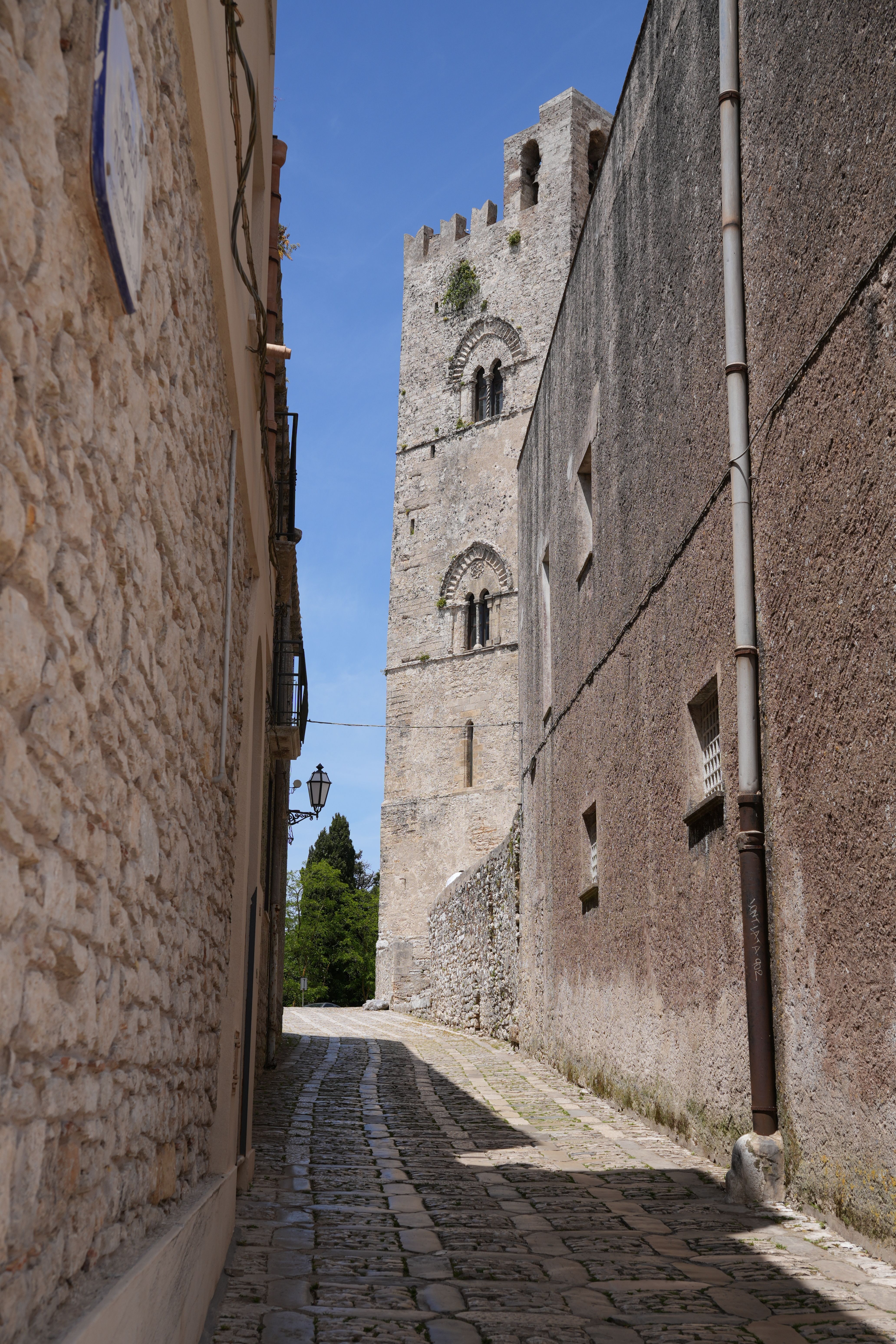 Explore the cobblestone streets of Erice, Sicily, showcasing medieval architecture and charming alleyways.