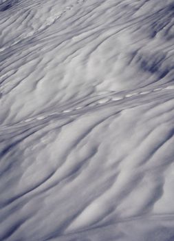 Detailed view of snow with unique ripples and patterns creating an abstract and artistic appearance.