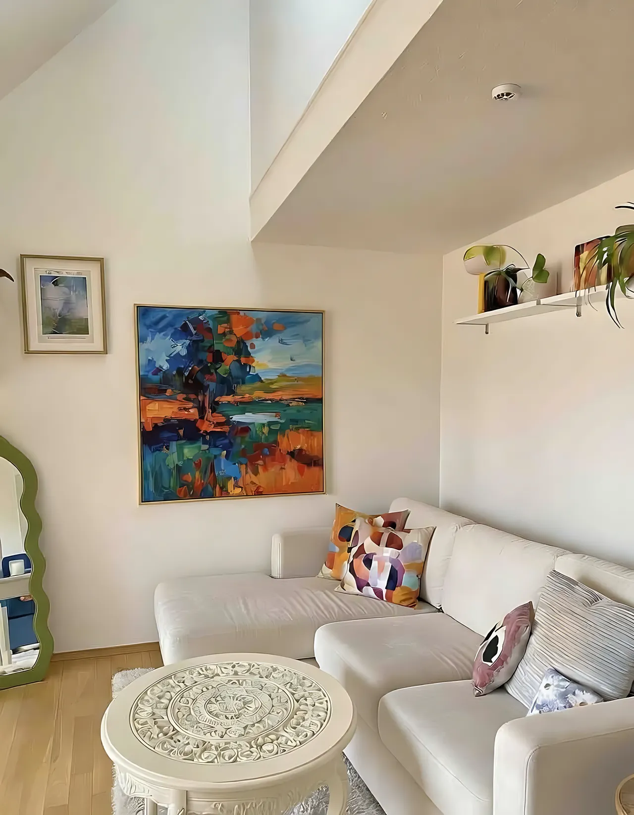 above-couch-wall-decor-ideas Above couch wall decor ideas: bright white living room with a large colorful abstract painting hung above the sofa