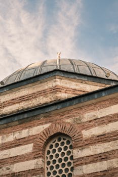 Captivating image of a historic dome with brick patterns under a blue sky, showcasing architectural beauty.